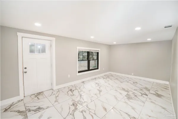 a view of an empty room and window