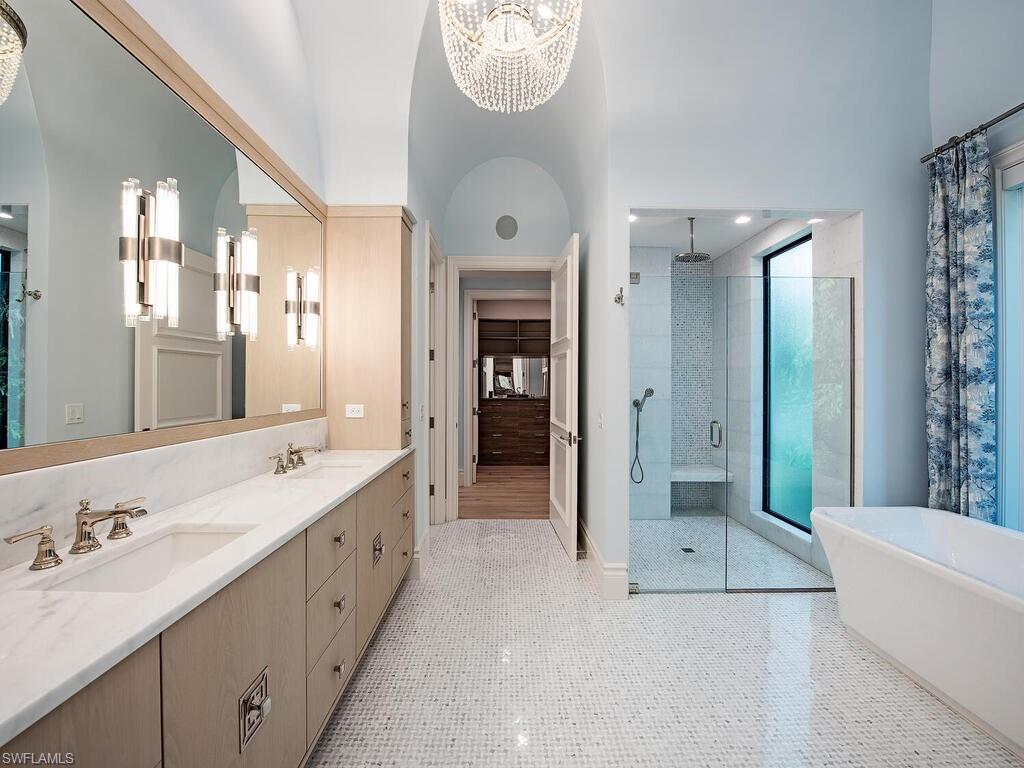 2375 Lantern Lane Naples, FL 34102 - Photo 11 of 45 a spacious bathroom with a bathtub shower and sink
