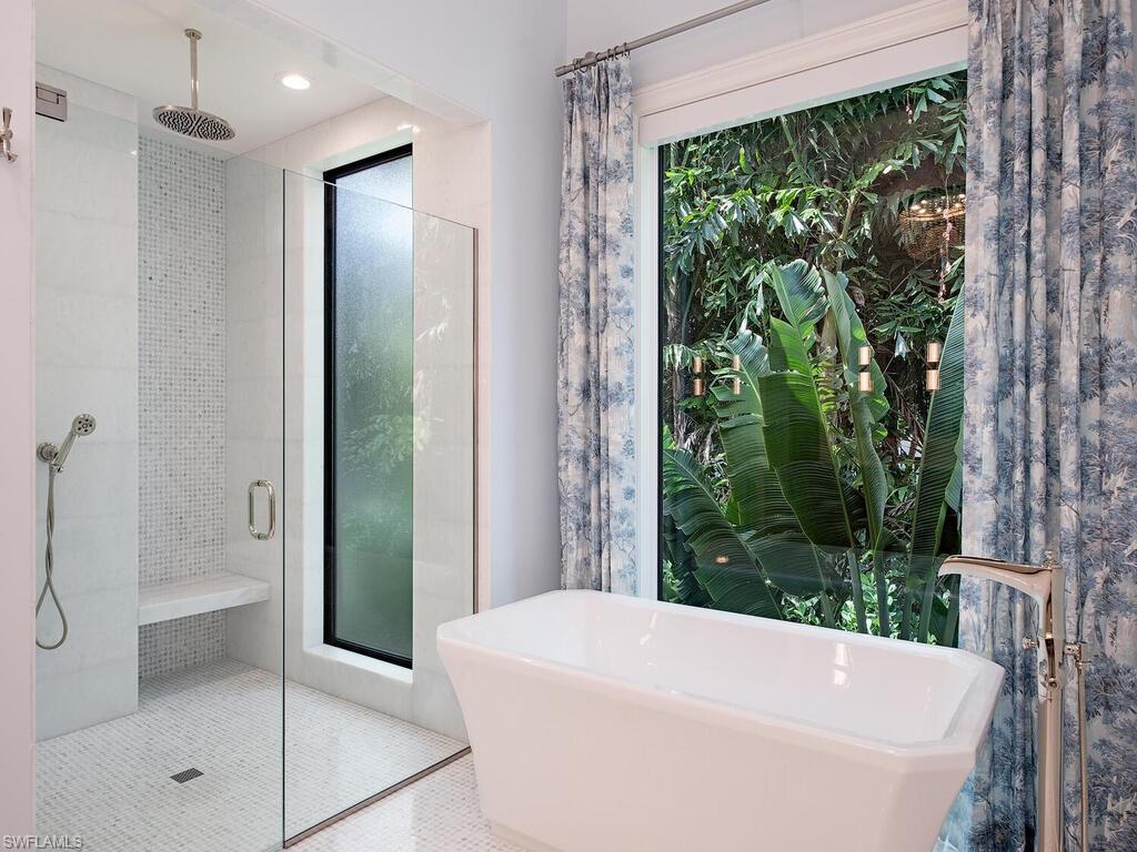 2375 Lantern Lane Naples, FL 34102 - Photo 12 of 45 a bathroom with a bathtub and shower
