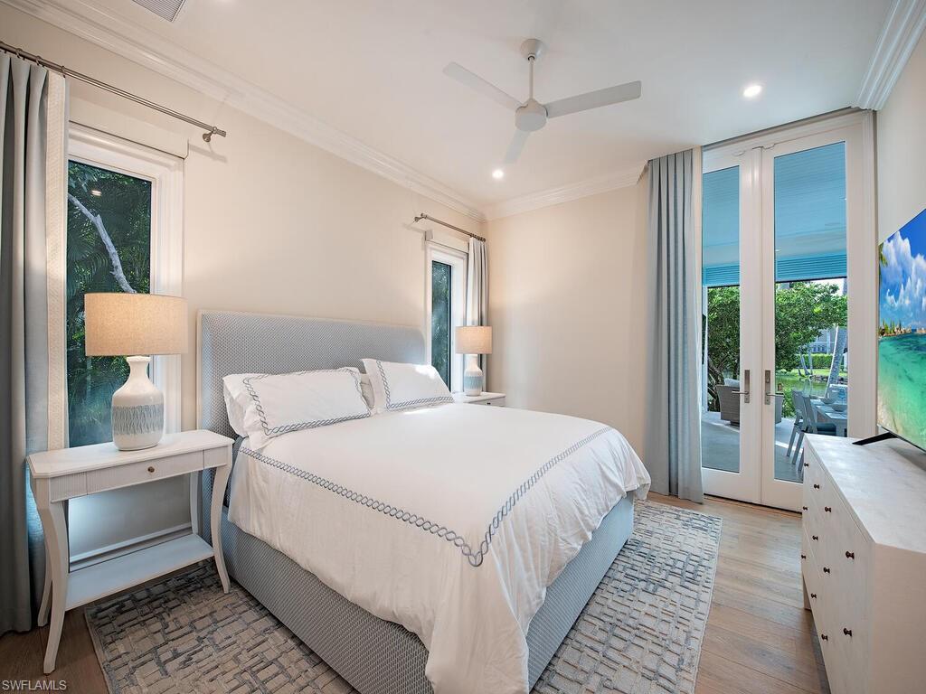 2375 Lantern Lane Naples, FL 34102 - Photo 13 of 45 a bedroom with a large bed and a window