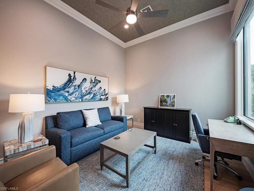 2375 Lantern Lane Naples, FL 34102 - Photo 22 of 45 a living room with furniture and a dining table with wooden floor