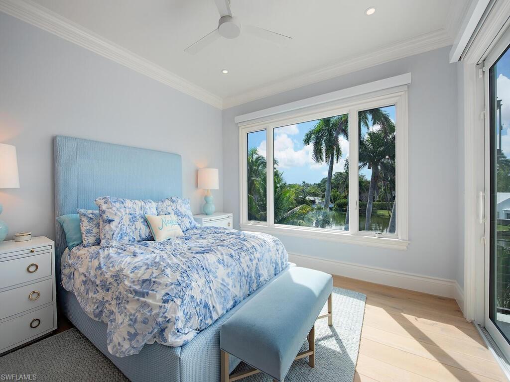 2375 Lantern Lane Naples, FL 34102 - Photo 25 of 45 a living room with furniture and a large window