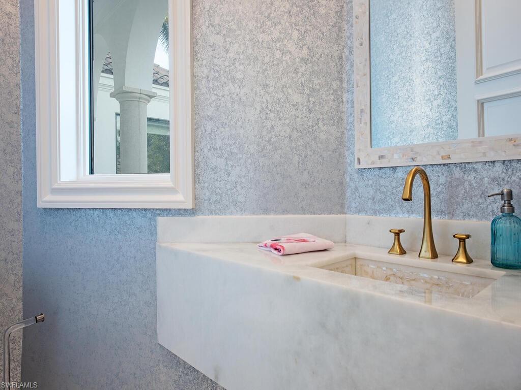 2375 Lantern Lane Naples, FL 34102 - Photo 28 of 45 a bathroom with a sink and a mirror