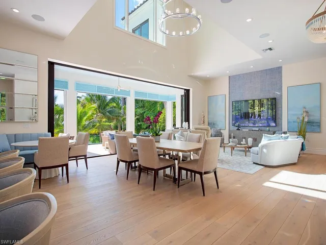 a dining room with furniture window and wooden floor