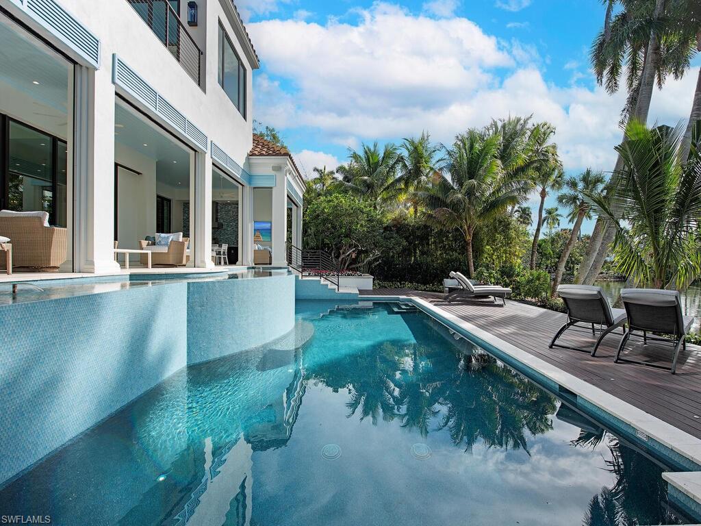 2375 Lantern Lane Naples, FL 34102 - Photo 31 of 45 a view of a house with pool and sitting area