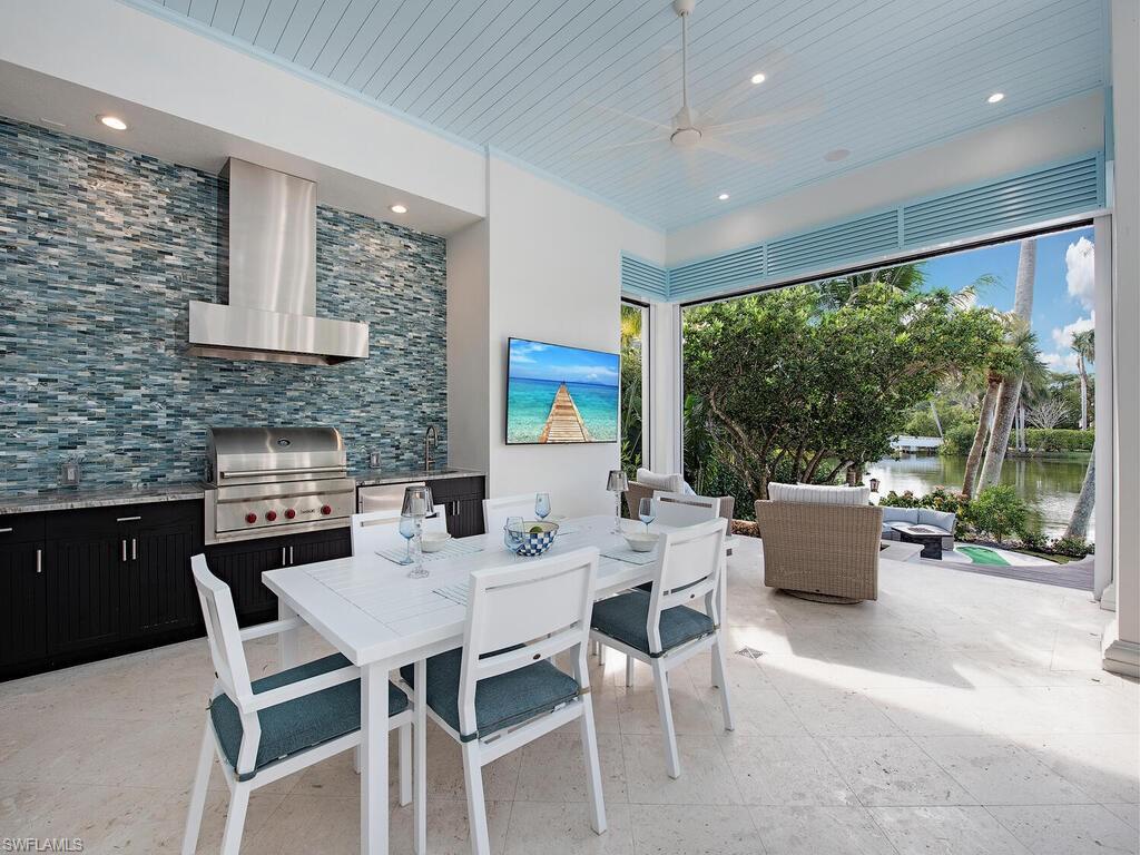 2375 Lantern Lane Naples, FL 34102 - Photo 36 of 45 a dining room with furniture and a floor to ceiling window
