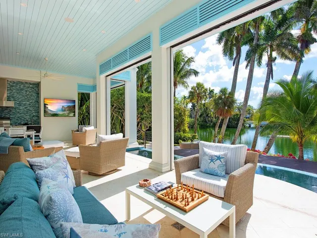 a spacious bedroom with a bed and a flat screen tv