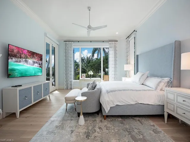 a bedroom with a large bed and a window