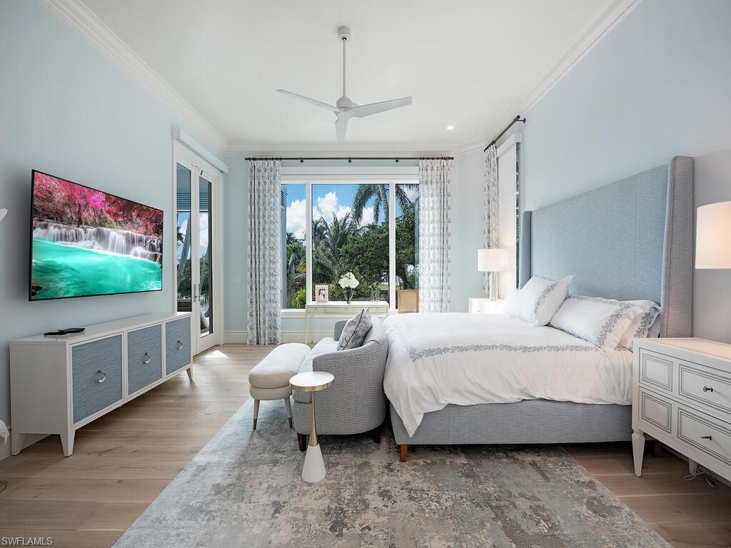 2375 Lantern Lane Naples, FL 34102 - Photo 10 of 45 a spacious bedroom with a bed and a flat screen tv
