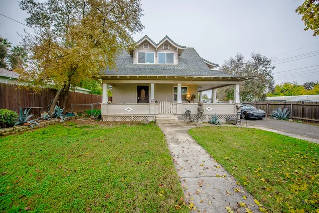 a front view of house with yard and outdoor seating