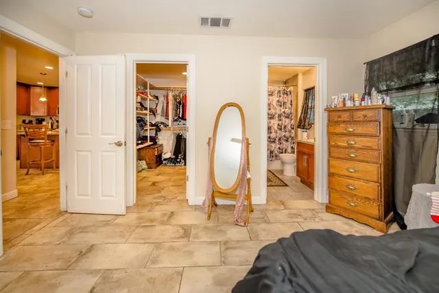 a bathroom with a granite countertop sink a toilet and a mirror