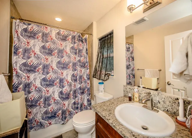 a spacious bedroom with a bed and a window