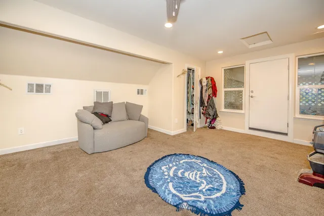 a spacious bathroom with a granite countertop sink mirror vanity and toilet