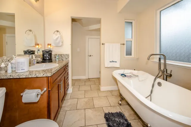a view of a deck with chairs and wooden fence