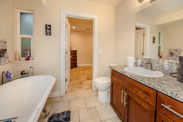 a backyard of a house with table and chairs