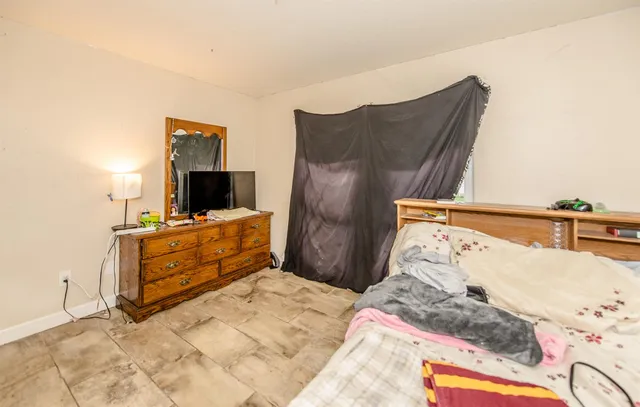 a view of a chair and table in backyard of the house