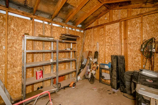 a view of a small house with wooden walls
