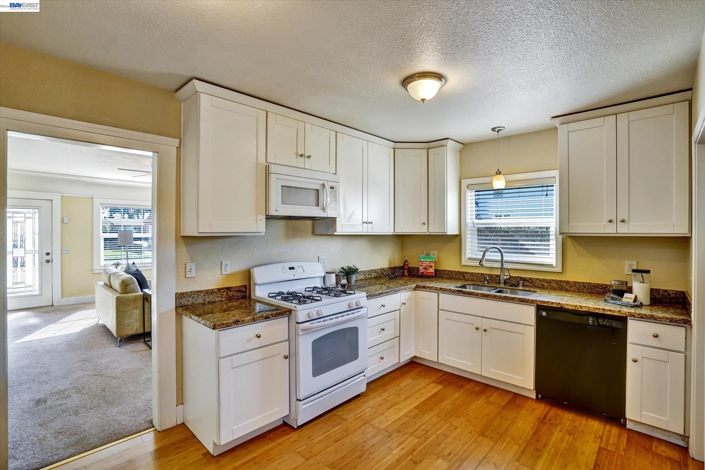 445 West Lowell Avenue Tracy, CA 95376 - Photo 11 of 44 a kitchen with cabinets a sink and appliances