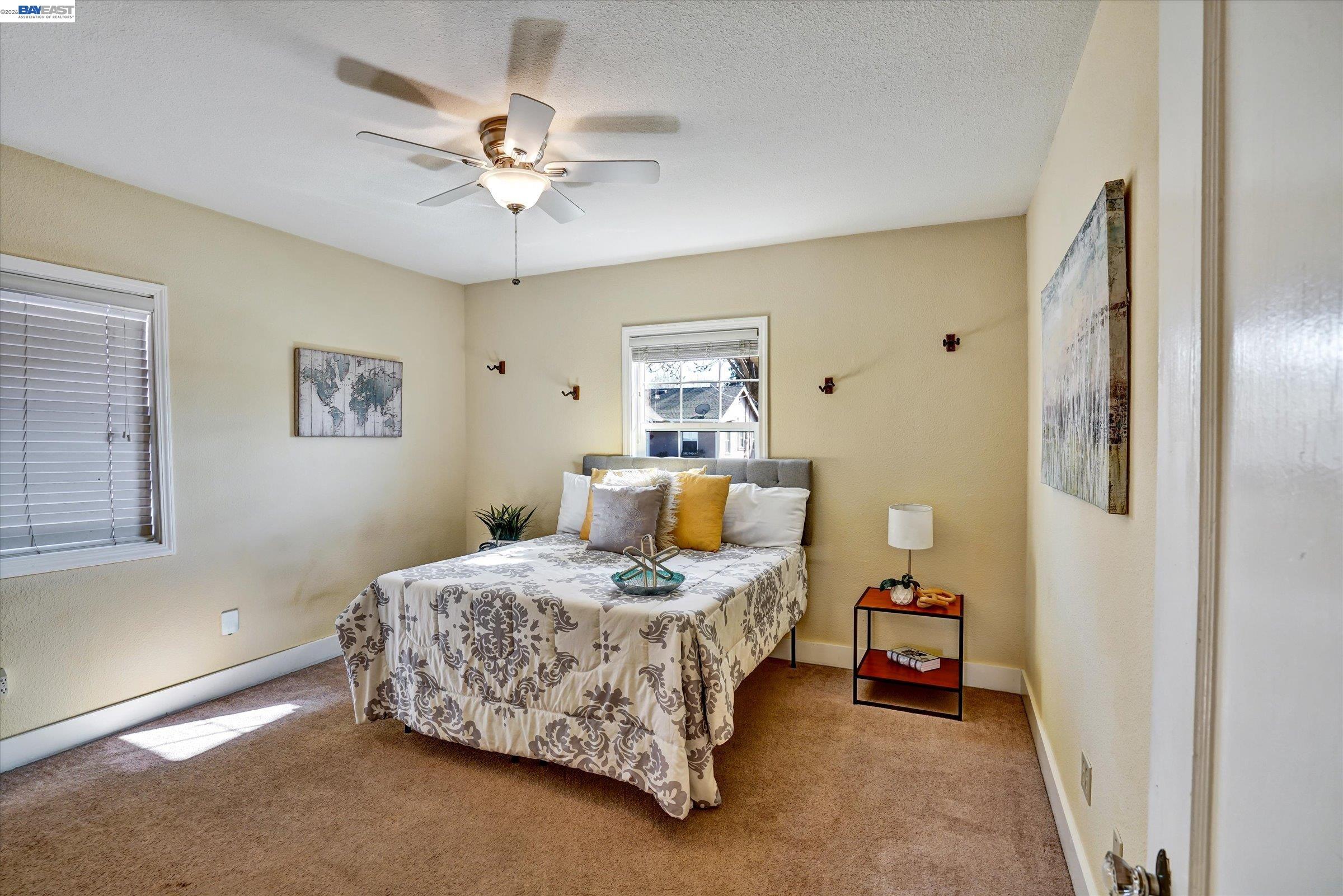 445 West Lowell Avenue Tracy, CA 95376 - Photo 18 of 44 a bedroom with a bed and a chandelier