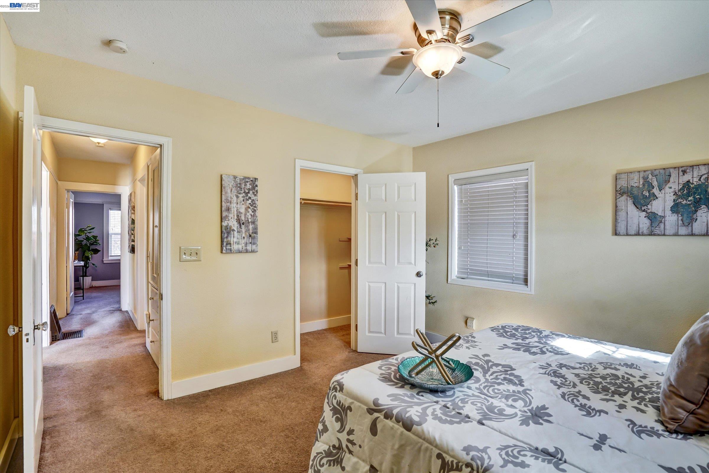 445 West Lowell Avenue Tracy, CA 95376 - Photo 19 of 44 a bedroom with a bed and a chandelier