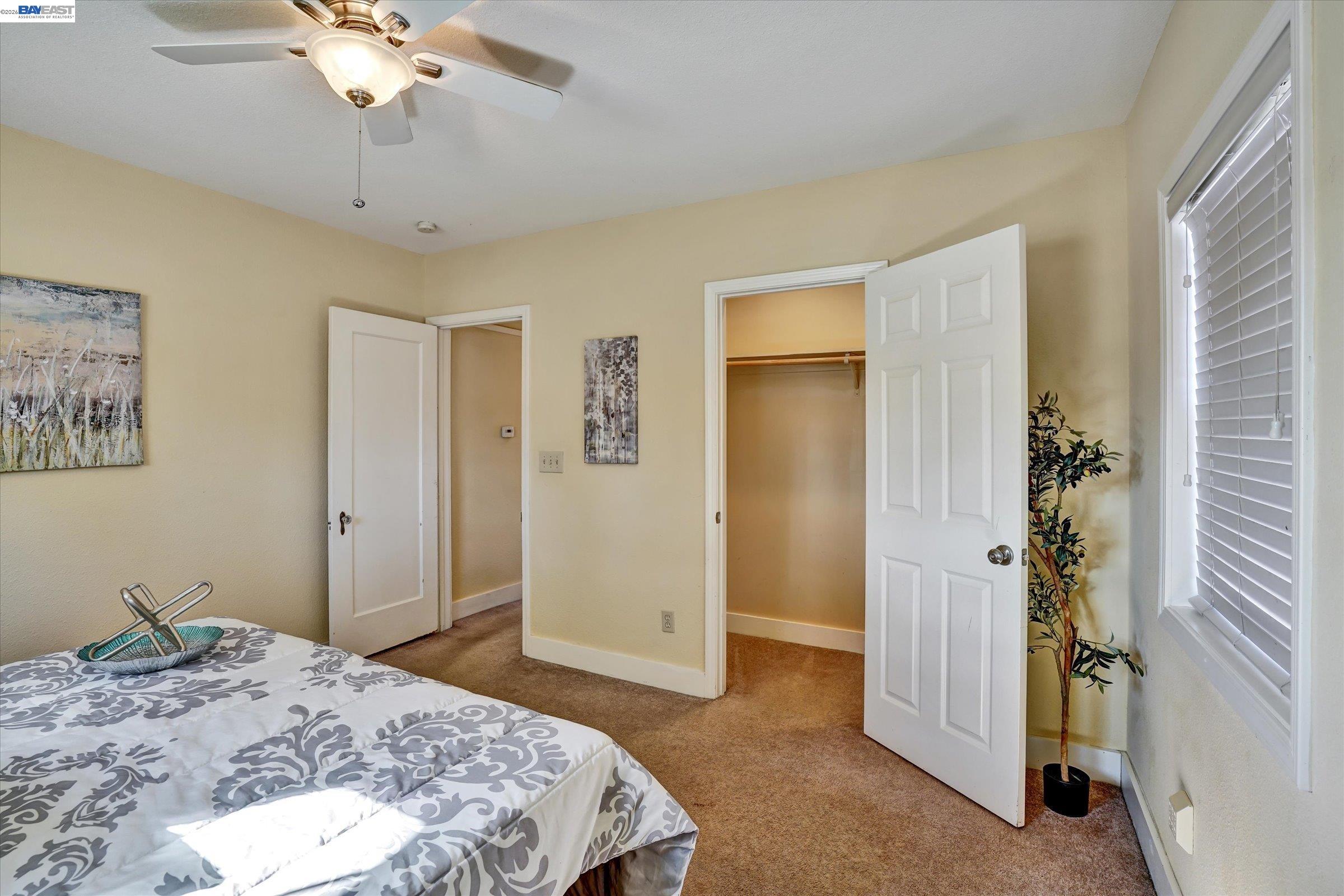 445 West Lowell Avenue Tracy, CA 95376 - Photo 22 of 44 a bedroom with a bed and a chandelier