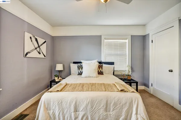 a bedroom with a large bed and a chandelier