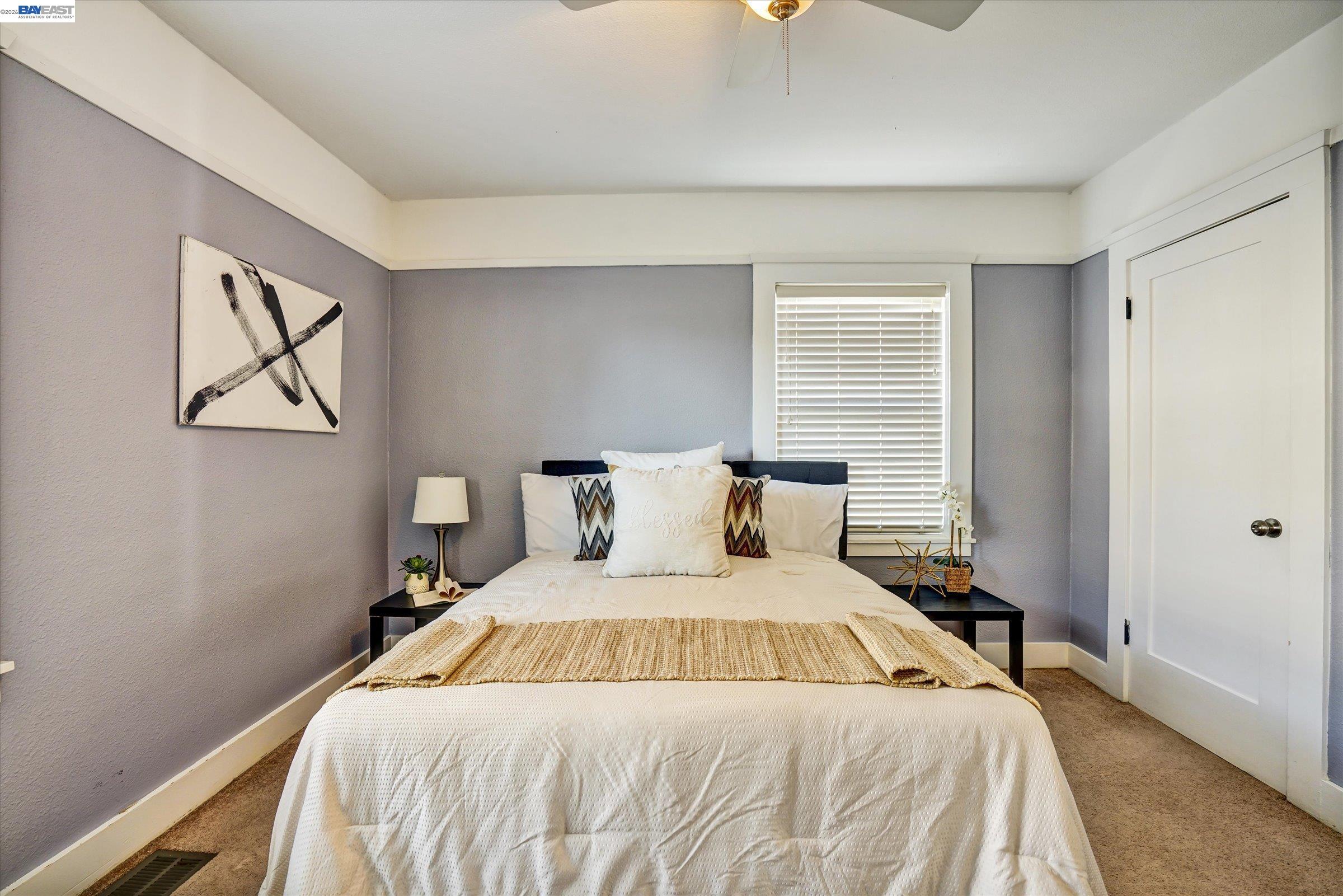 445 West Lowell Avenue Tracy, CA 95376 - Photo 28 of 44 a bedroom with a large bed and a chandelier