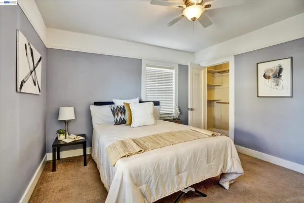 a bedroom with bed and a chandelier