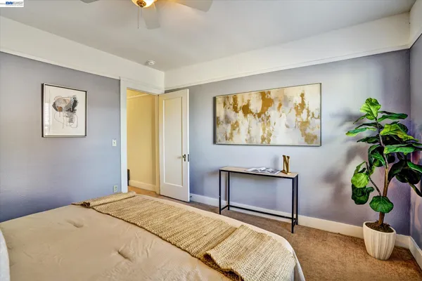 a bedroom with a bed and a potted plant