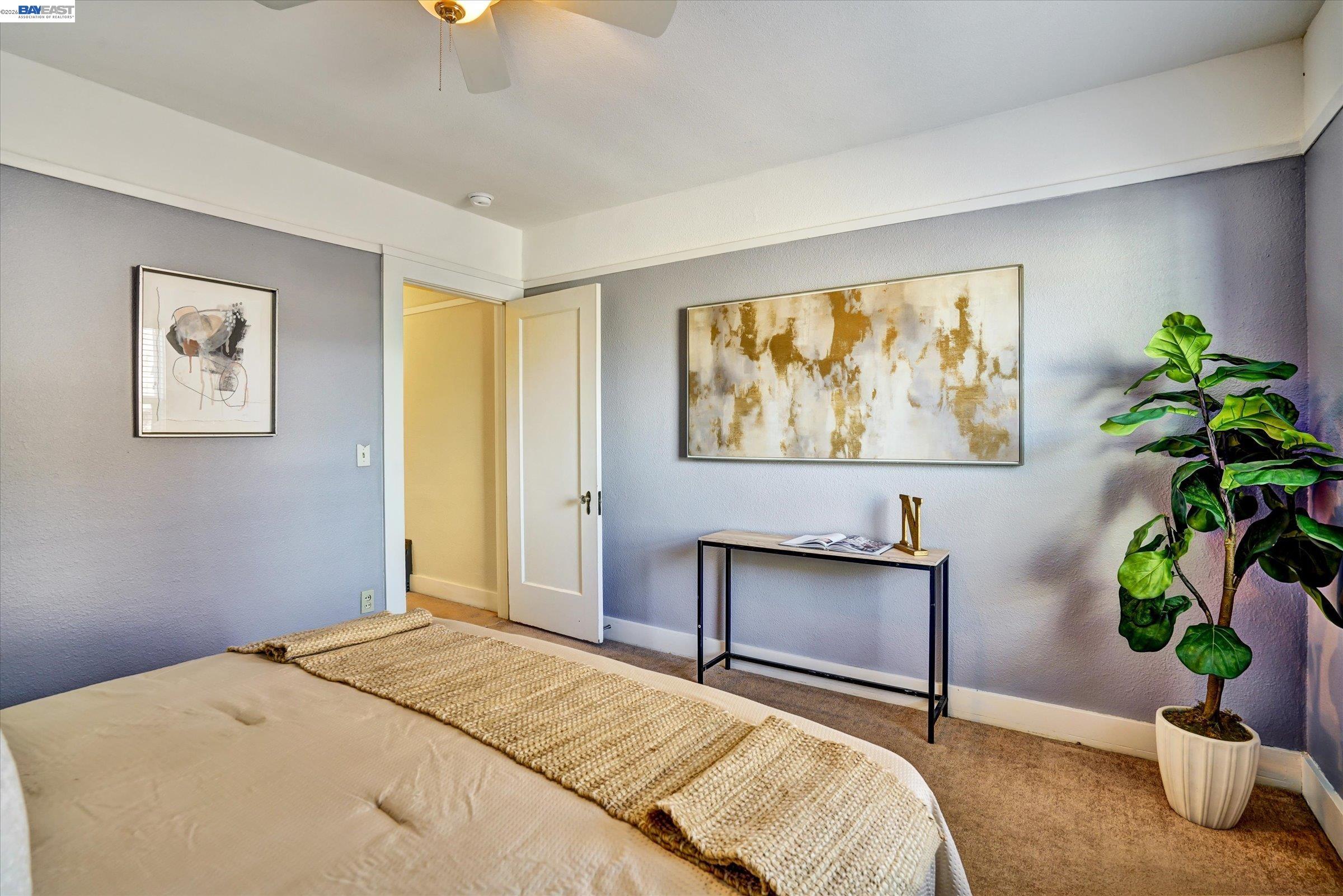 445 West Lowell Avenue Tracy, CA 95376 - Photo 32 of 44 a bedroom with a bed and a potted plant