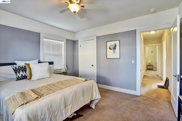 a bedroom with a large bed and a chandelier