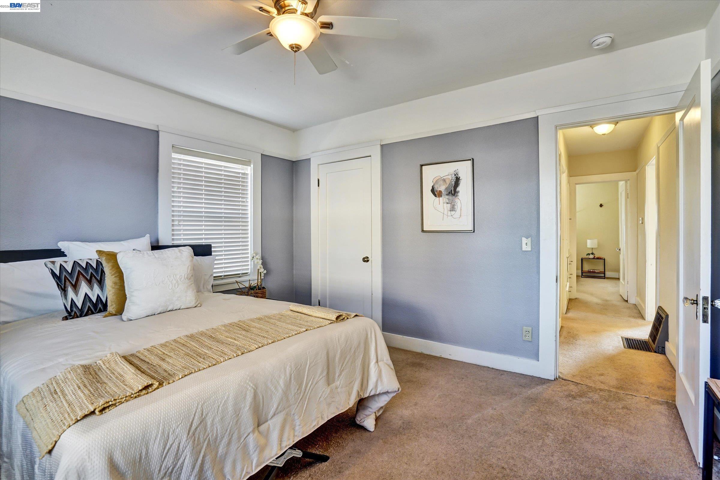 445 West Lowell Avenue Tracy, CA 95376 - Photo 33 of 44 a bedroom with a large bed and a chandelier