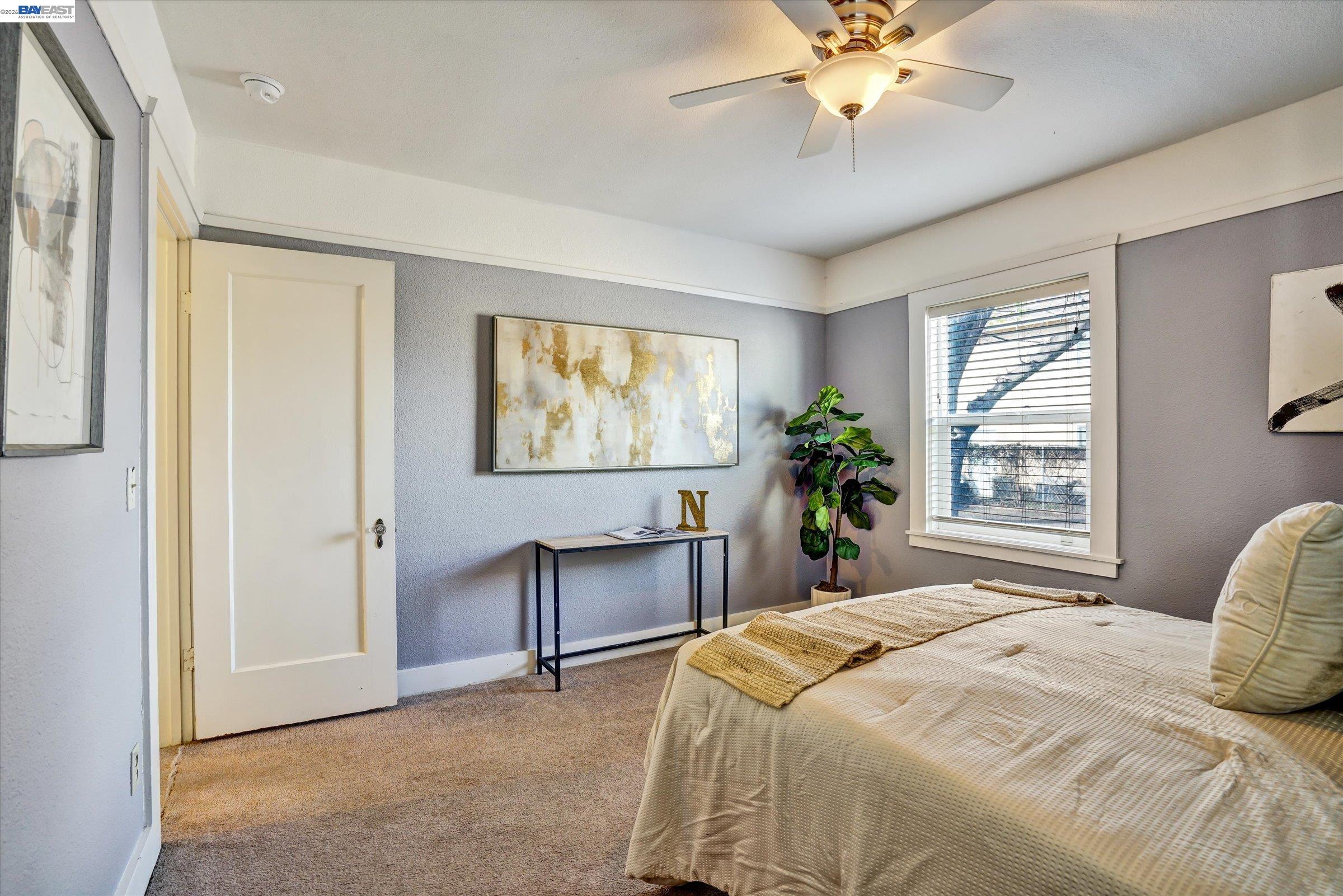 445 West Lowell Avenue Tracy, CA 95376 - Photo 34 of 44 a bedroom with a large bed and a chandelier