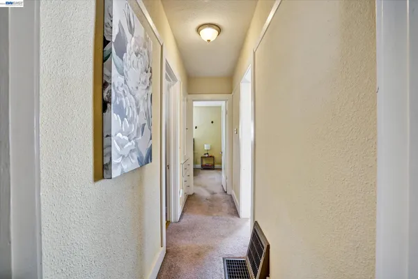 a view of a hallway with wooden shelves