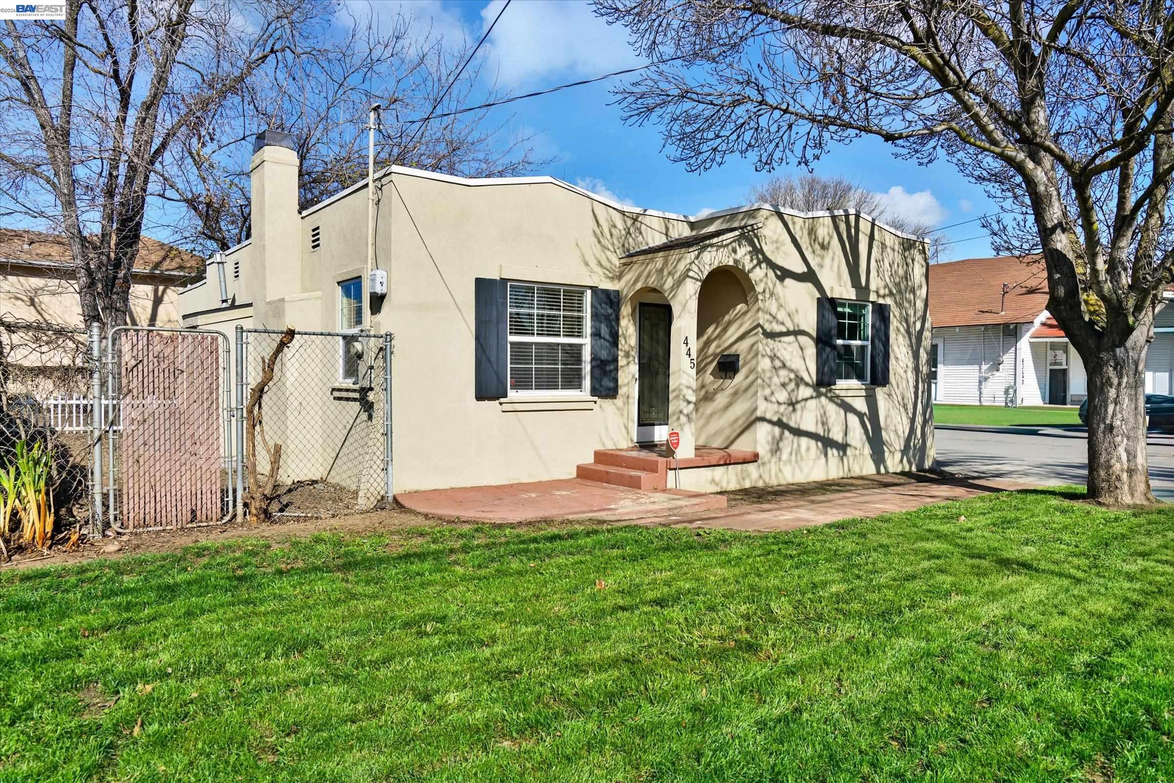 445 West Lowell Avenue Tracy, CA 95376 - Photo 37 of 44 a view of a backyard with brick wall and a large tree