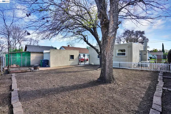 a view of a house with a tree in front of it