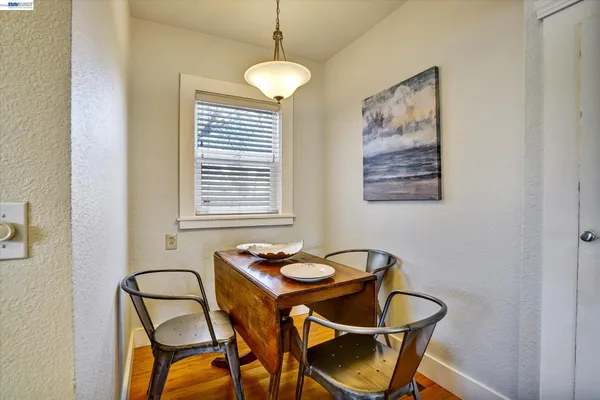 a dining room with furniture and window