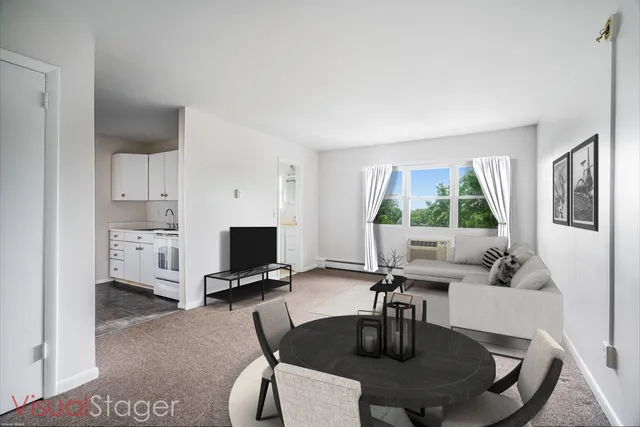 a dining room with furniture and a window
