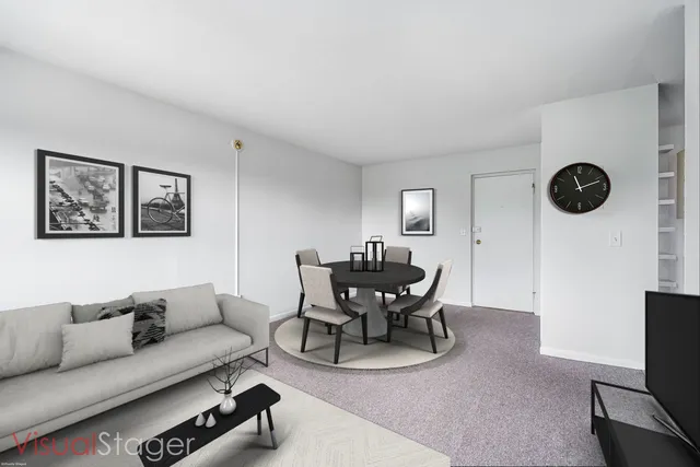 a living room with furniture a rug and wall clock