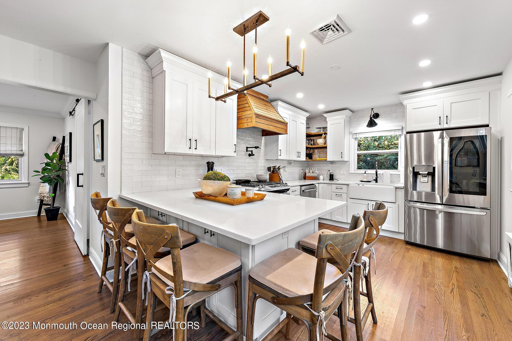 7 Sagamore Avenue Oceanport, NJ 07757 - Photo 11 of 44 a kitchen with stainless steel appliances granite countertop a dining table chairs refrigerator and sink