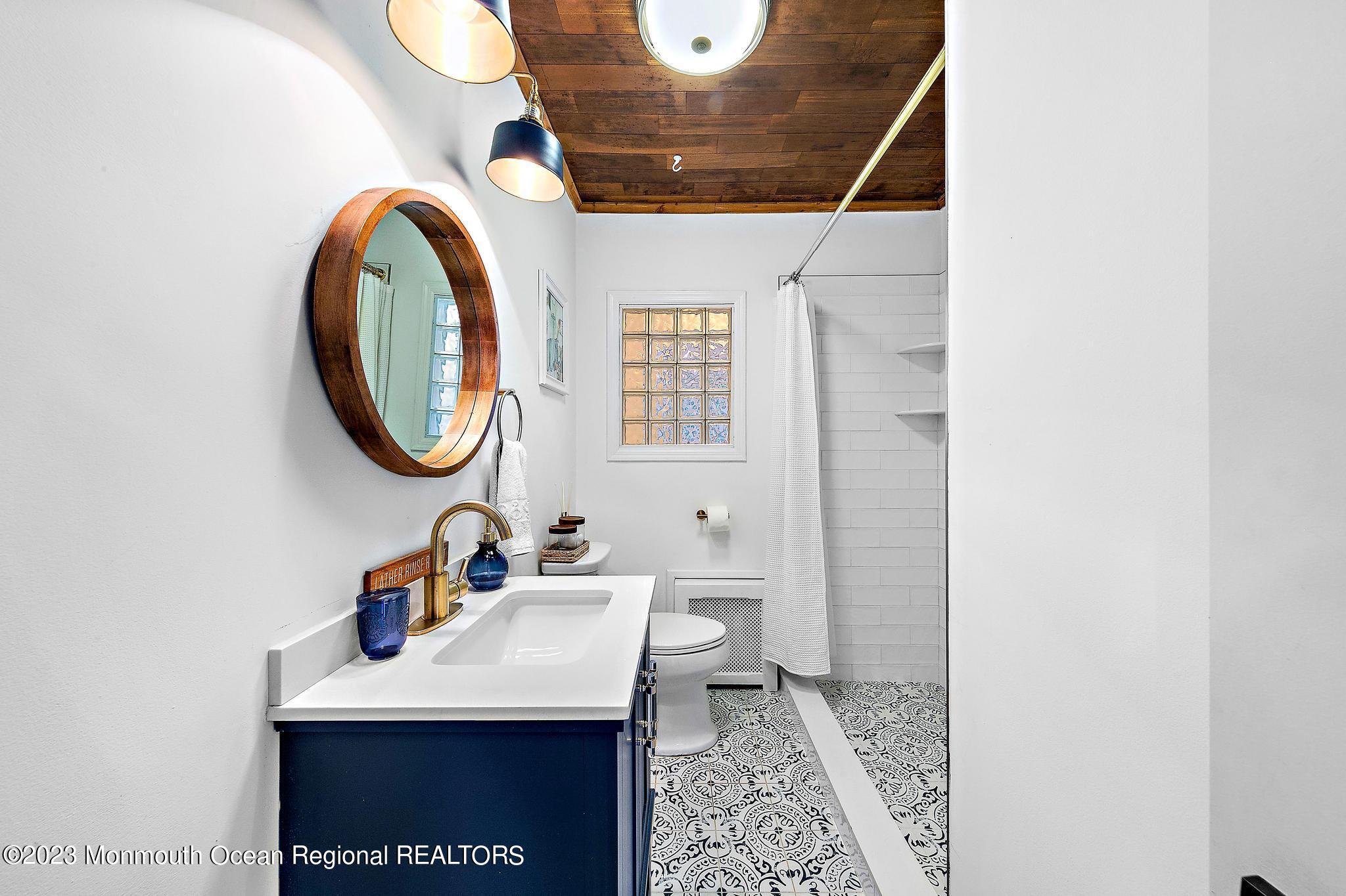 7 Sagamore Avenue Oceanport, NJ 07757 - Photo 22 of 44 a bathroom with a sink a mirror and a toilet