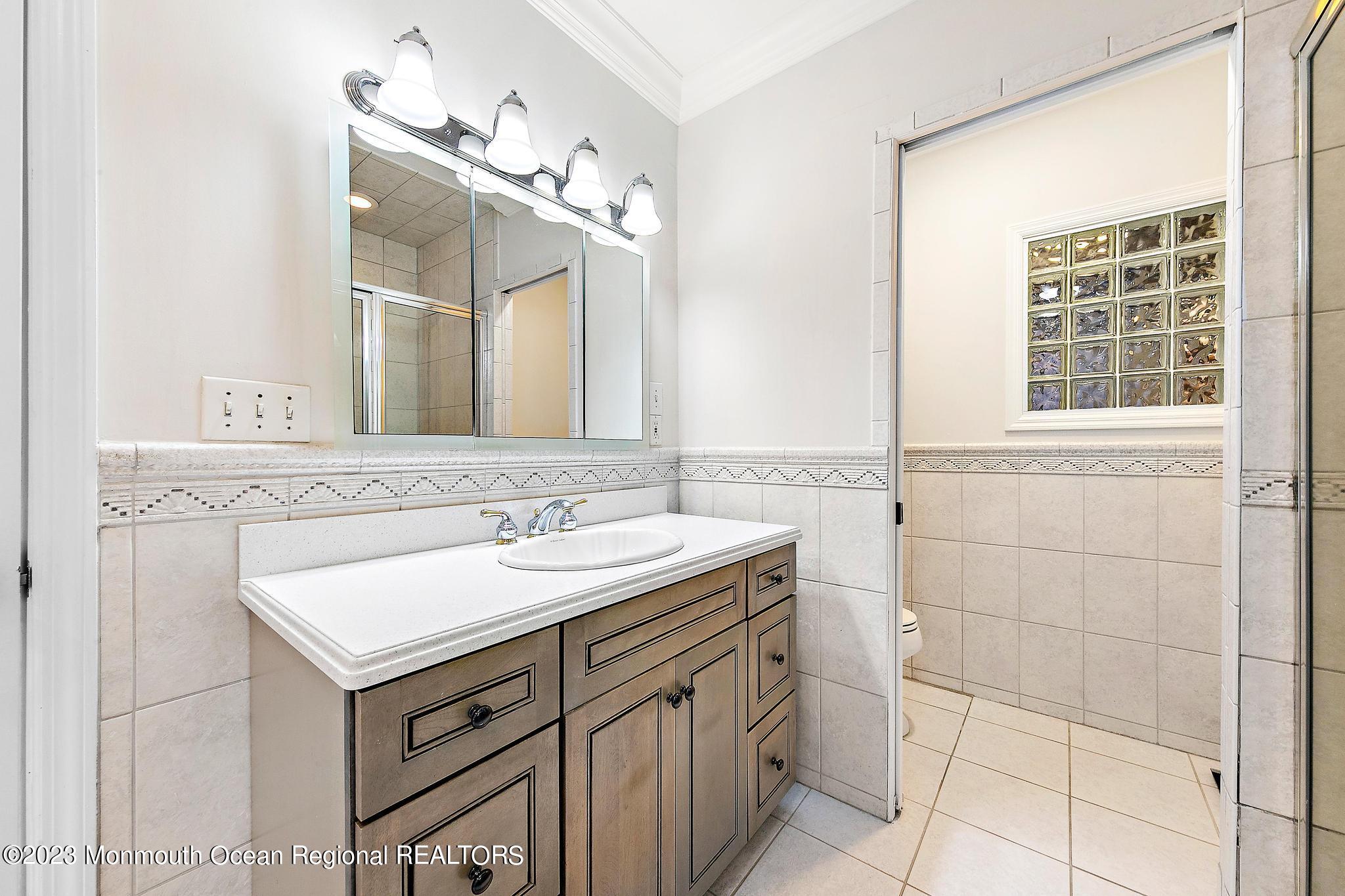 7 Sagamore Avenue Oceanport, NJ 07757 - Photo 29 of 44 a bathroom with a sink and a mirror