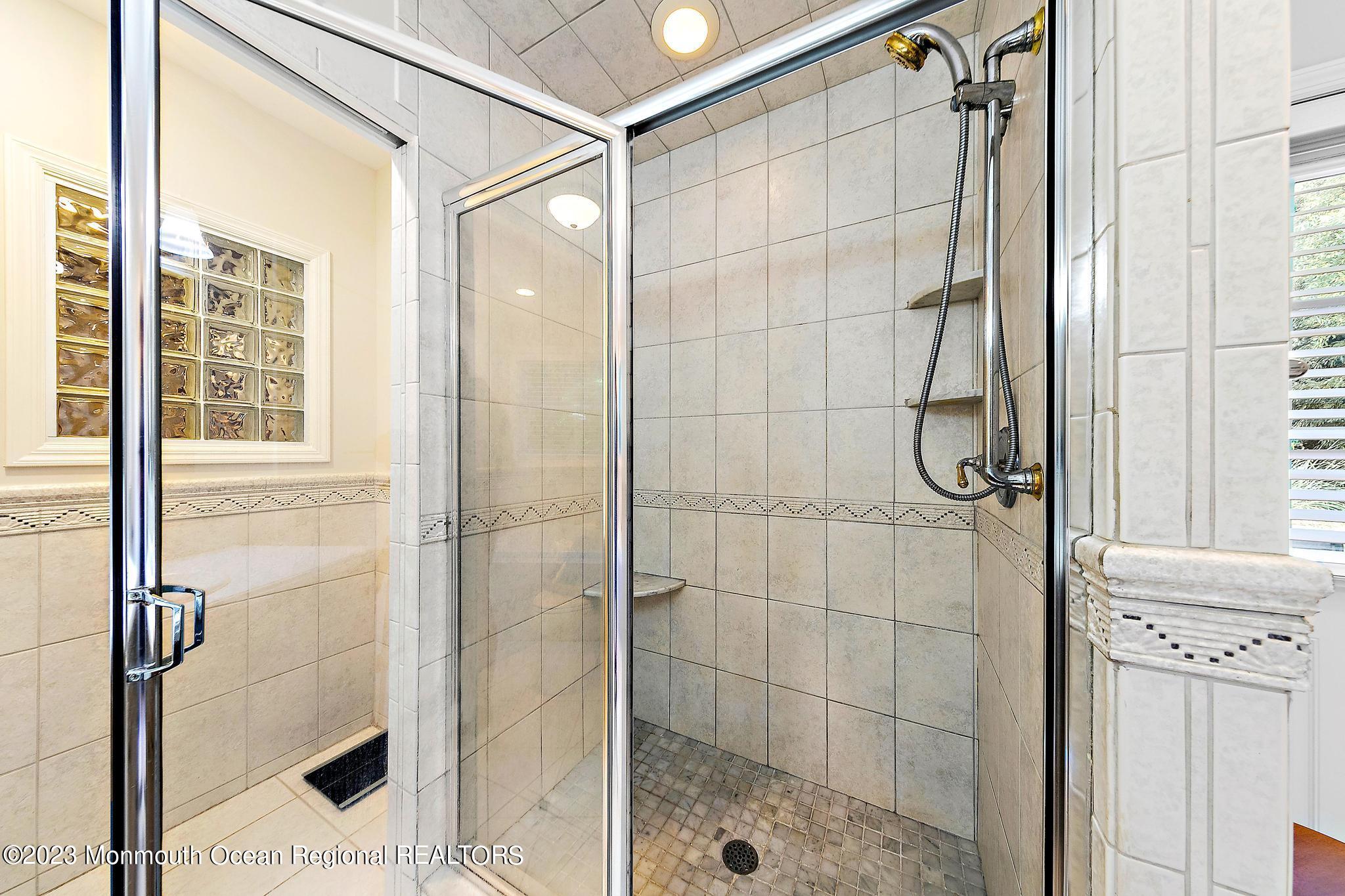 7 Sagamore Avenue Oceanport, NJ 07757 - Photo 30 of 44 a bathroom with a glass shower door