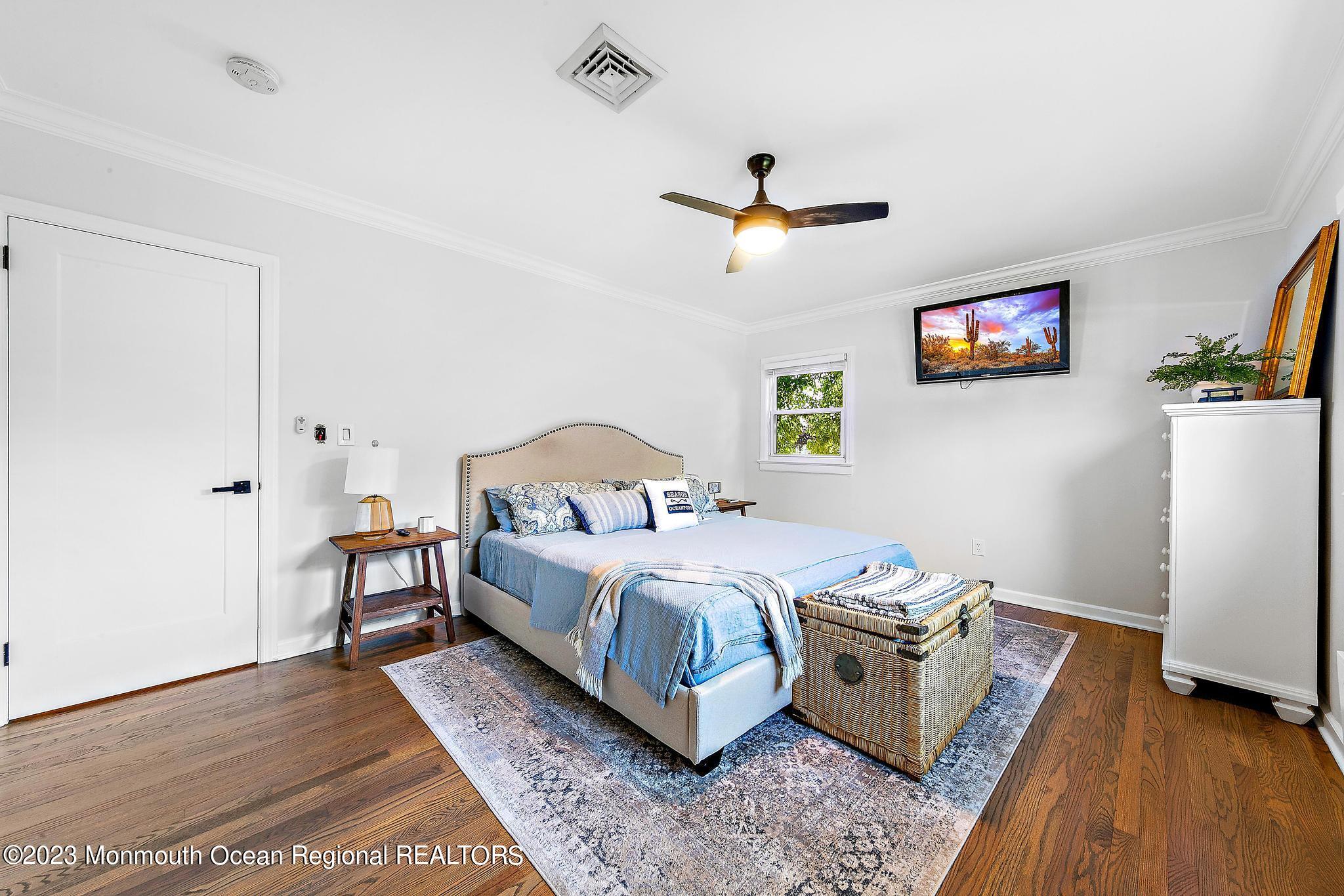 7 Sagamore Avenue Oceanport, NJ 07757 - Photo 34 of 44 a bedroom with a bed and a chandelier