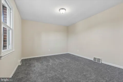 an empty room with a empty space and windows