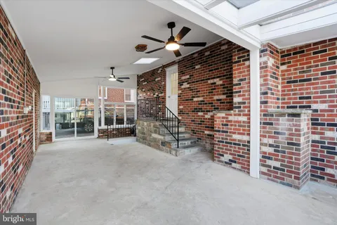 a view of empty room with wooden ceiling fan