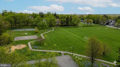a view of a garden with a building in the background