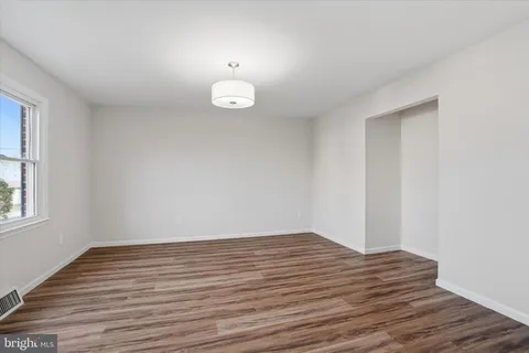 a view of a room with wooden floor and natural light