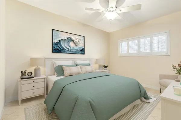 a bedroom with a bed and a painting on the wall