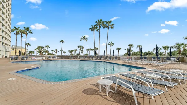 a view of a swimming pool with outdoor seating